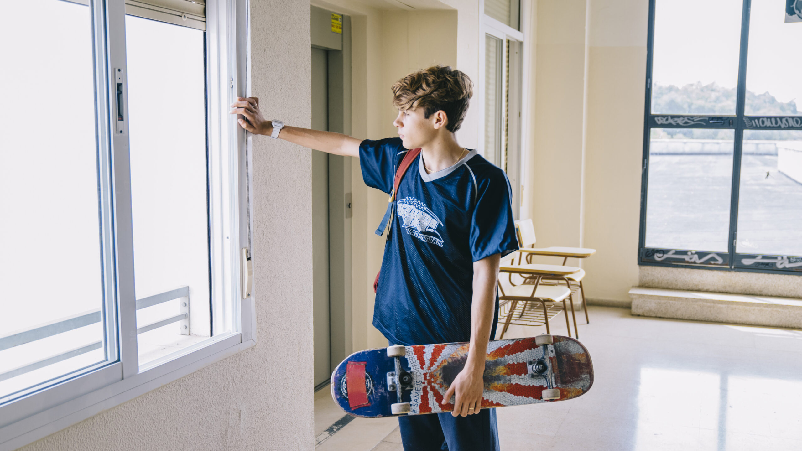 boy-with-skateboard-looking-through-window